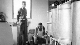 Ben Fairburn (left) and Rex Bramble check the honey in one of the vats.